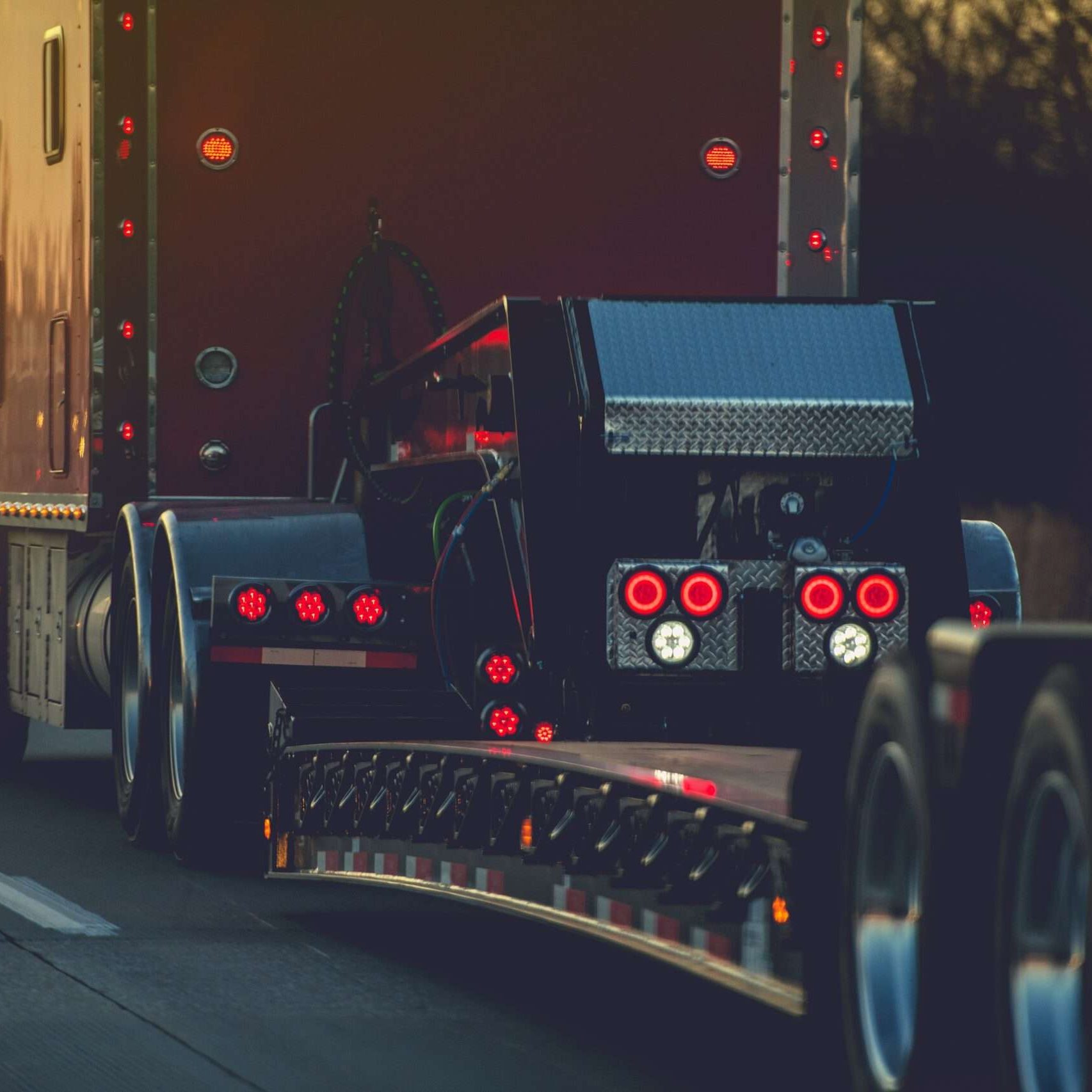 Semi Truck with Heavy Duty Platform Trailer on a Route. Transportation Industry.
